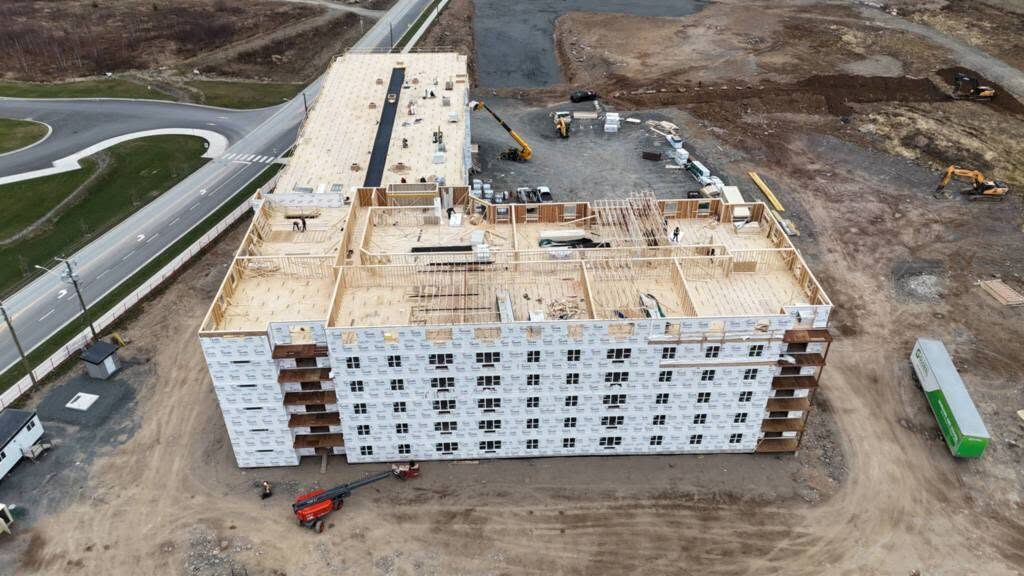 Aerial view of the building with framing topped out and the envelope underway