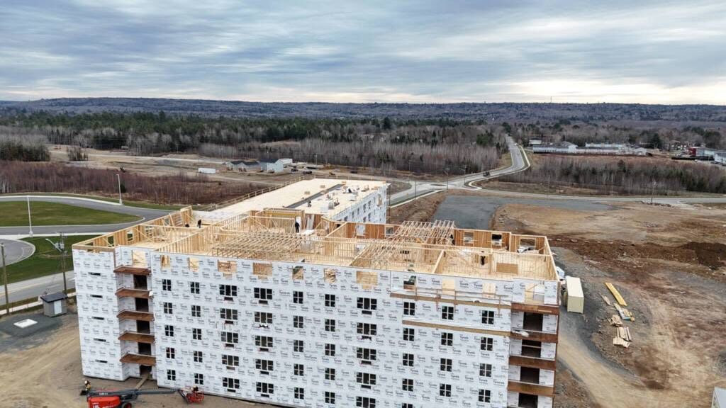 Six-storey rental building at 100 Cuffman Street with framing complete and the envelope going on