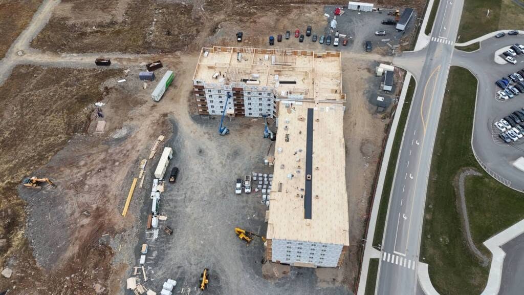 Top-down view of the roof deck across the length of the building