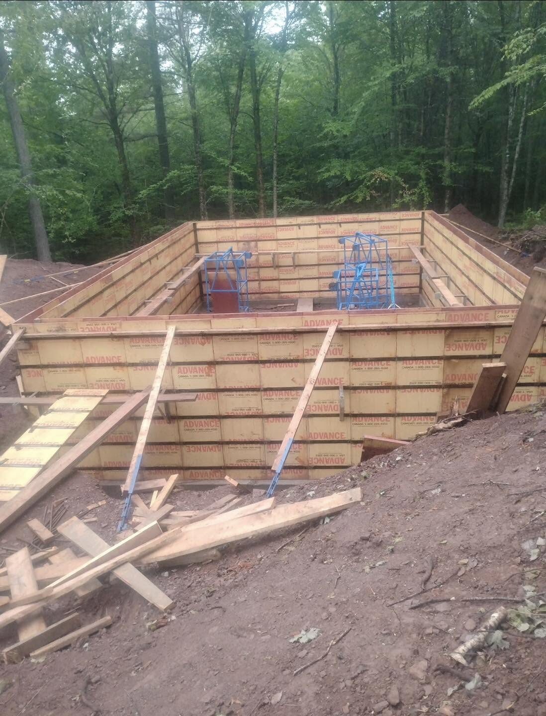 Formed eight-foot foundation walls for a cabin on a wooded lot at Grand Lake