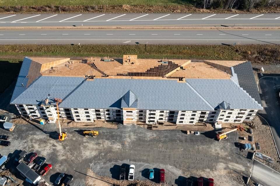 Aerial view of the U-shaped building around its courtyard with framing complete