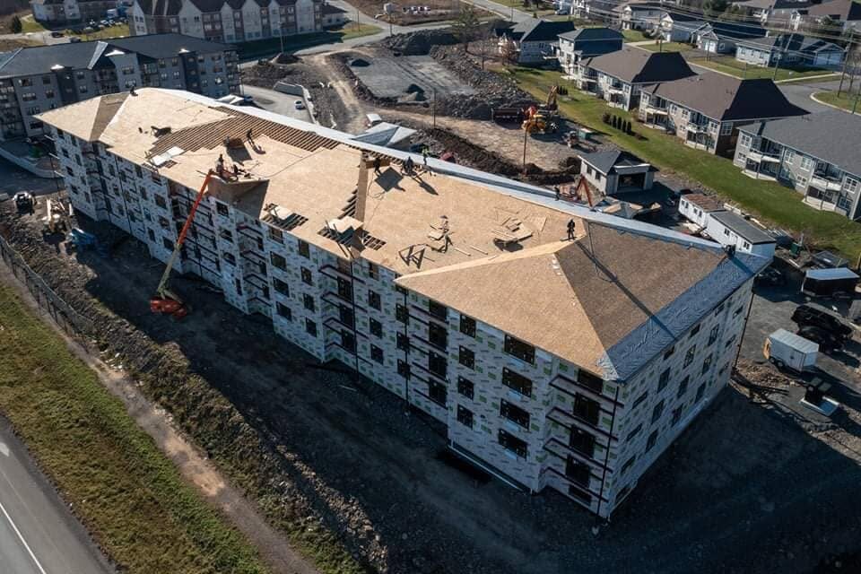 Roof sheathing going on over the trusses