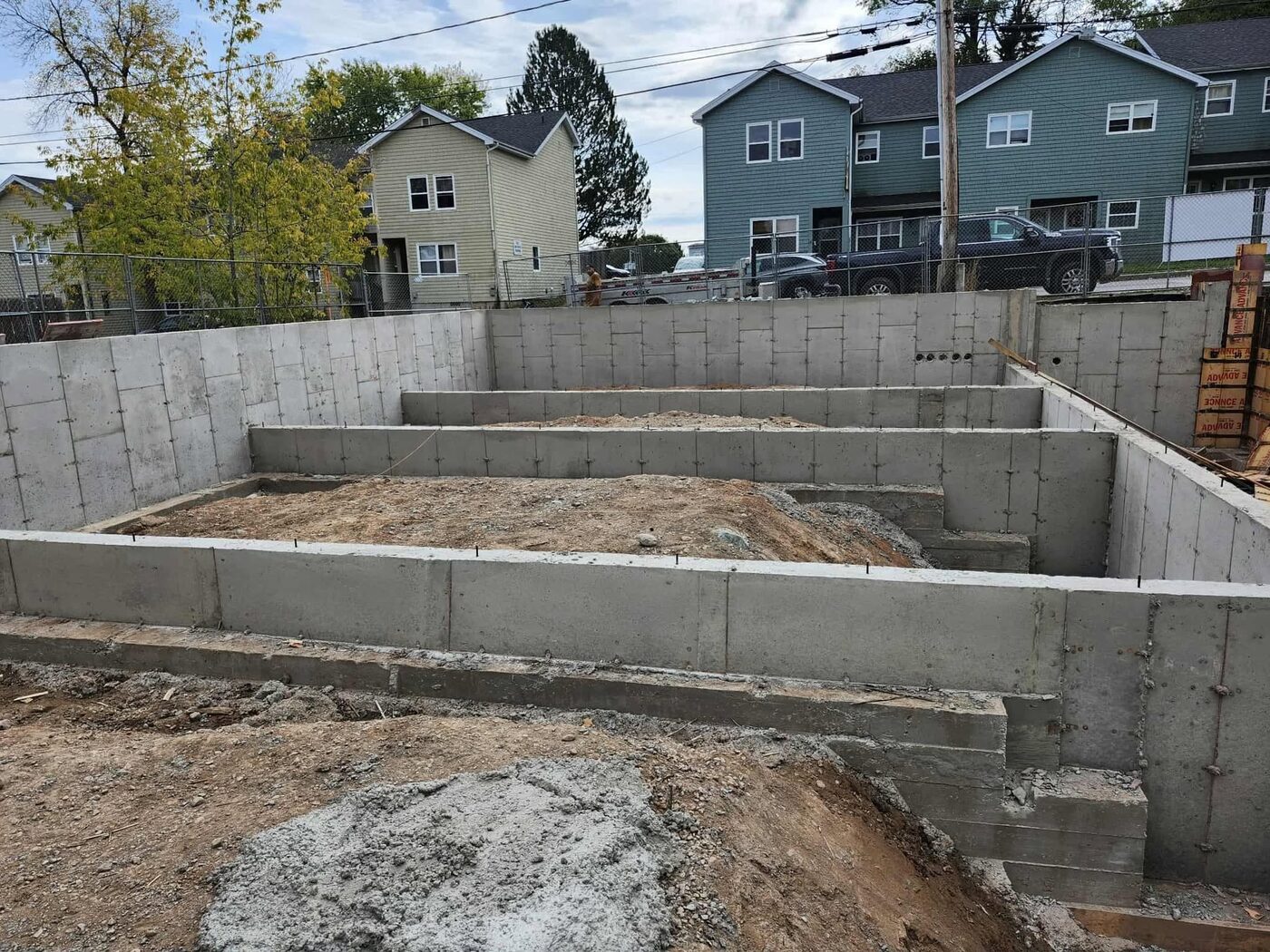 Wide view of the completed foundation walls across the full building footprint