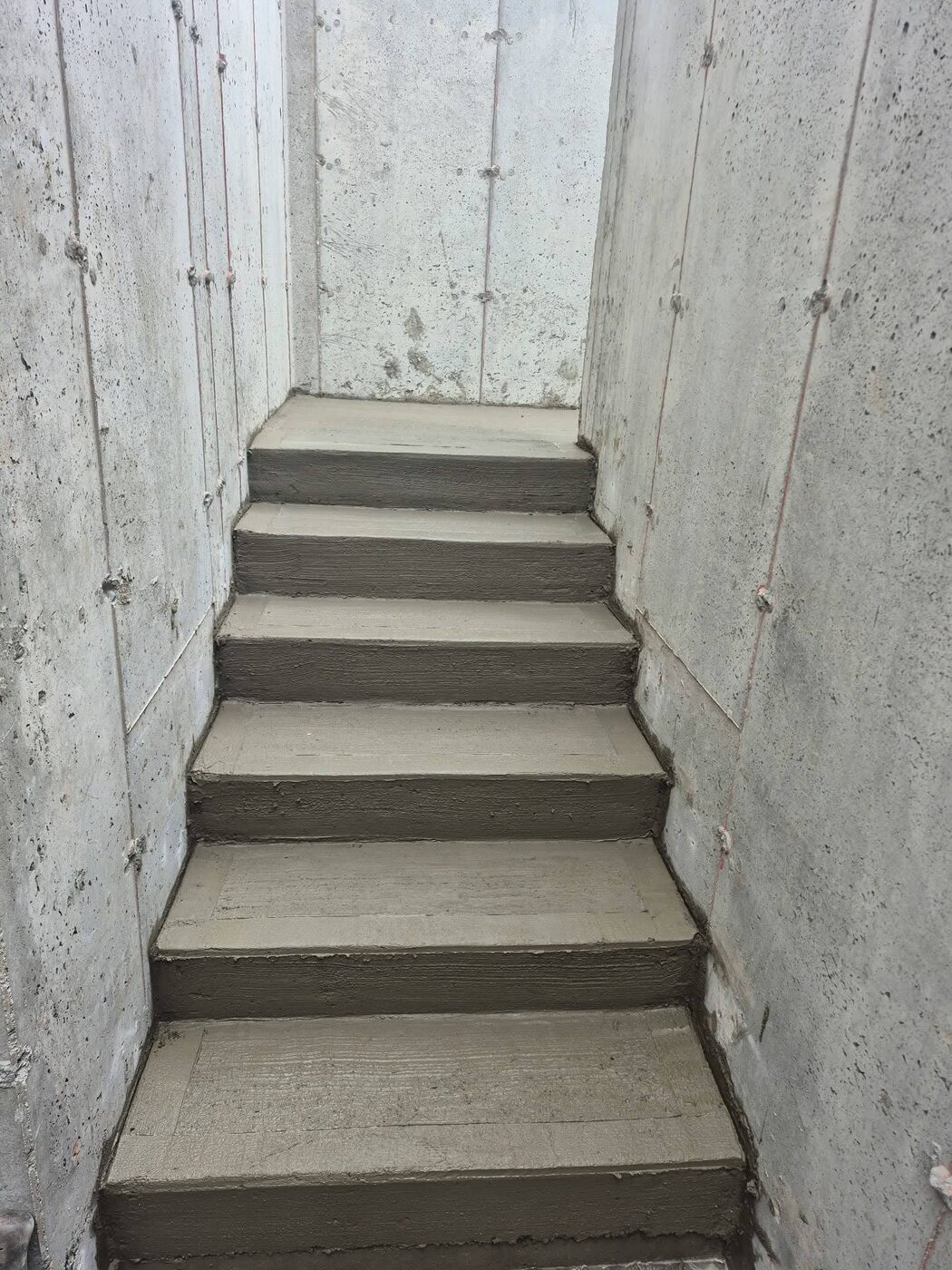 Cast-in-place concrete stair flight inside a finished core