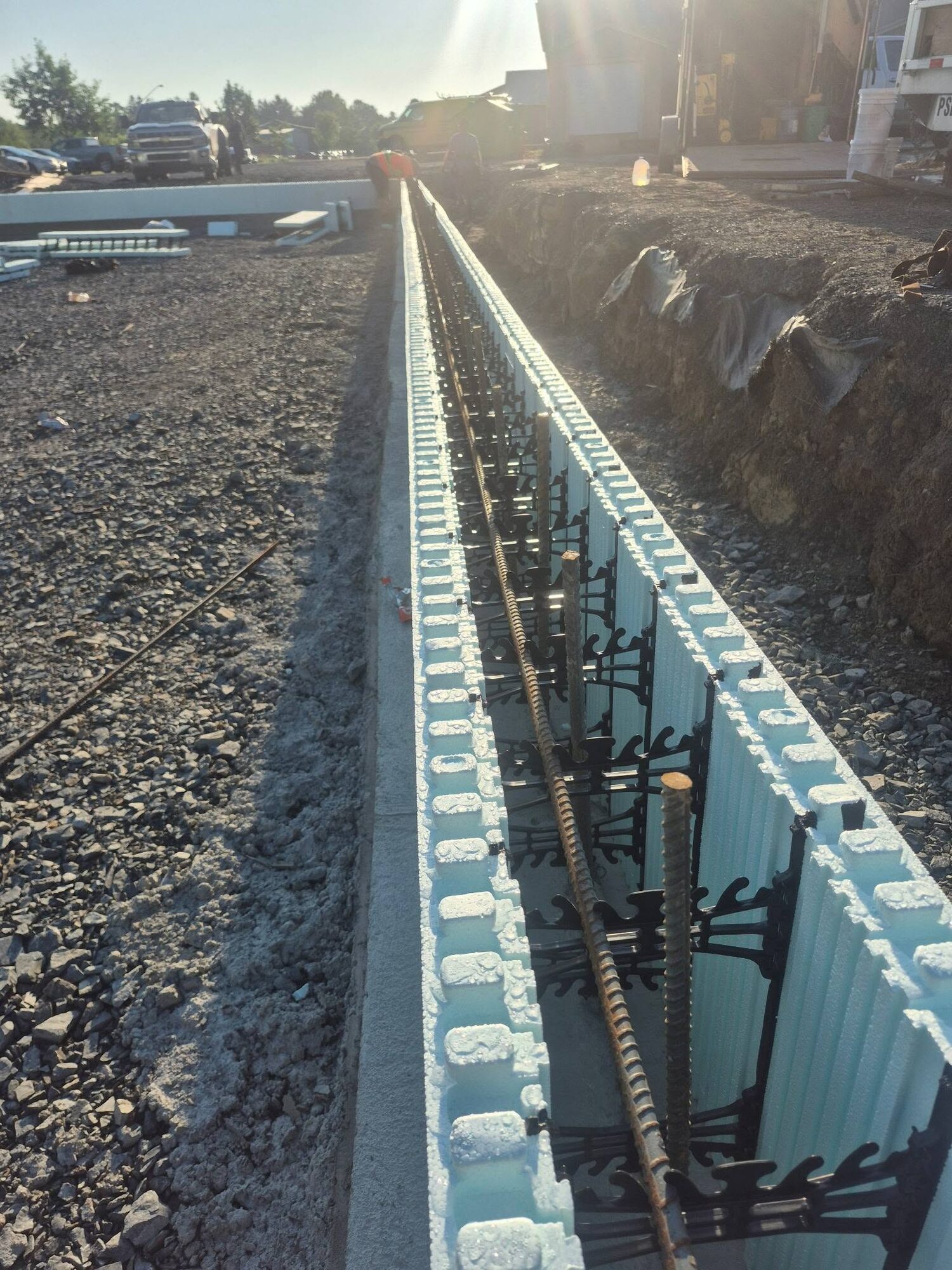 Formed foundation wall running the length of the ServiceMaster shop footprint with rebar in place