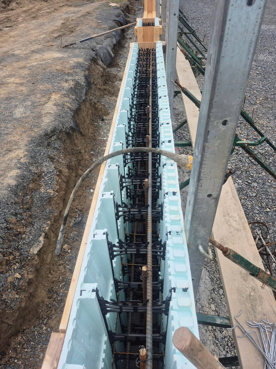 Wall forms set in the trench with rebar tied through