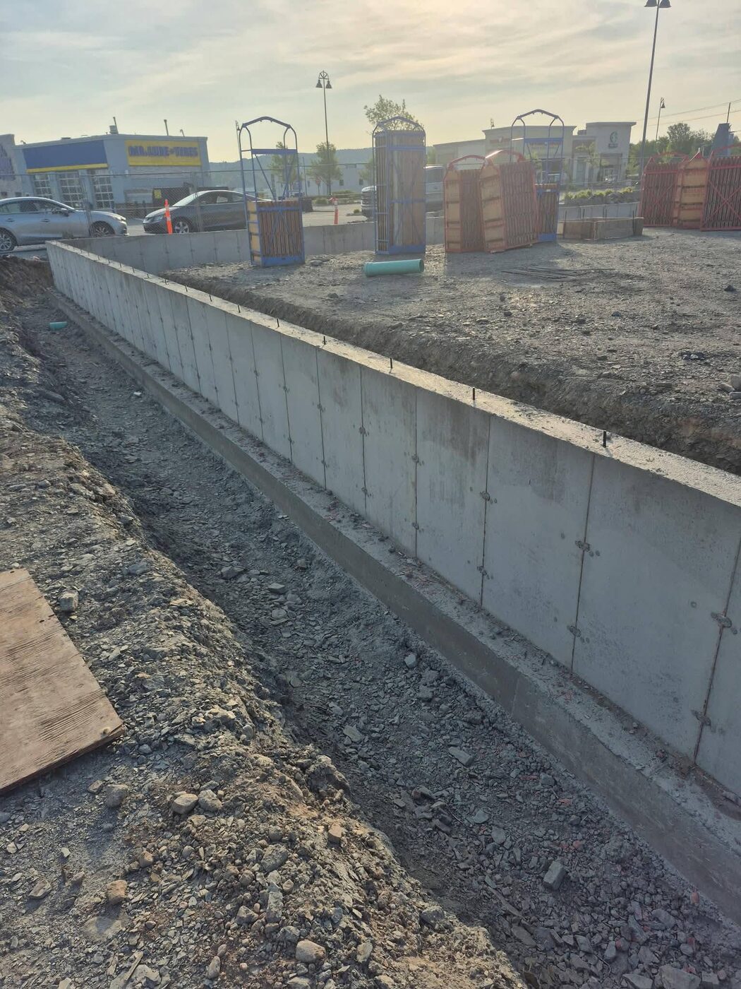 Stripped frost wall running the length of the site in evening light