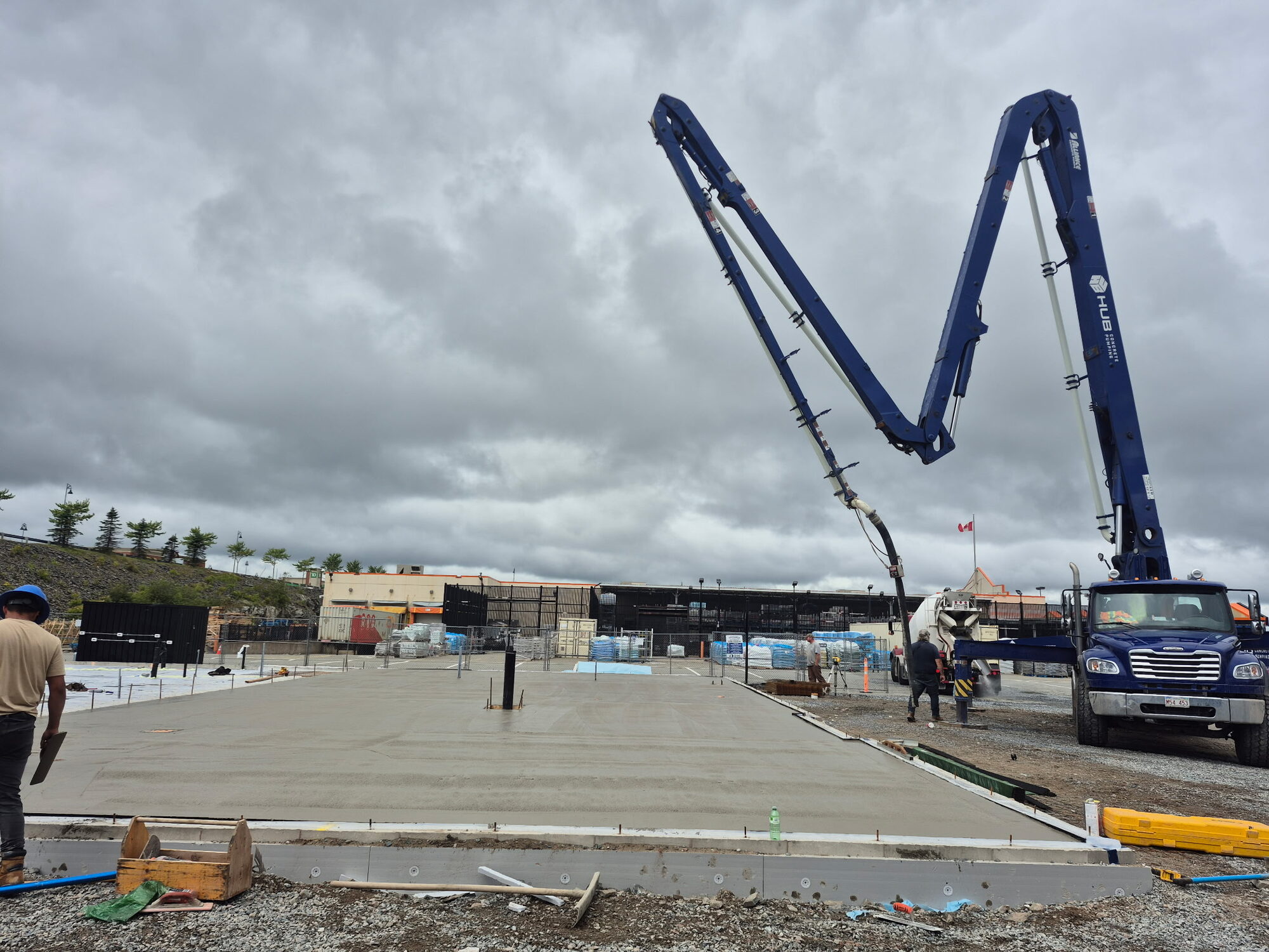 Boom pump placing the building slab on the Swiss Chalet pad in Saint John